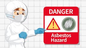 Cartoon style character in full protective white overalls and mask with blue gloves pointing to an asbestos hazard sign
