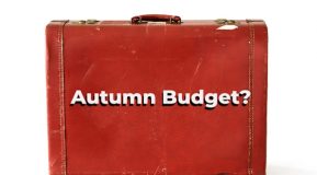 Image of a battered reddish brown briefcase with the text Autumn Budget? in white