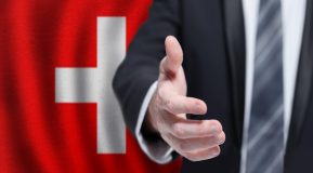 Swiss business politics cooperation and travel concept Hand on flag of Switzerland background Freepik premium